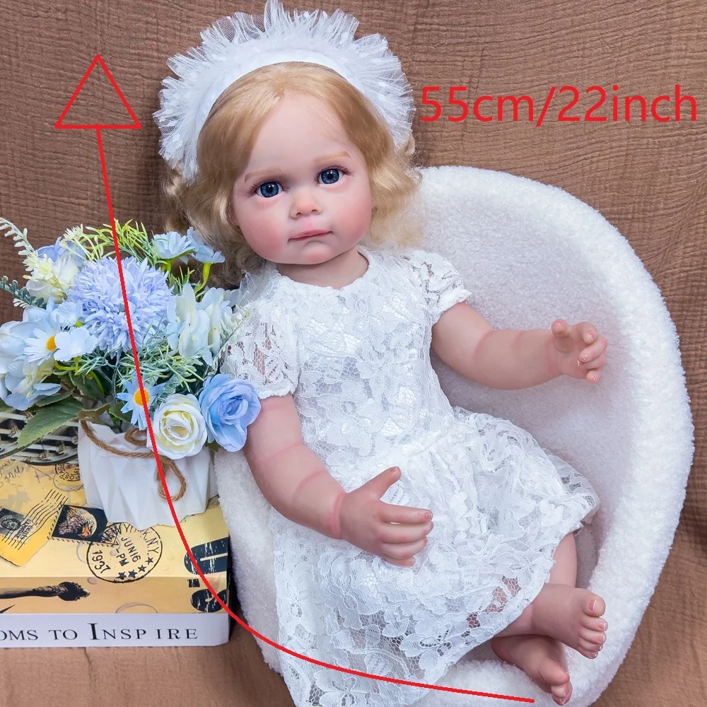 ตุ๊กตาไวนิลรีบอร์นขนาด 22 นิ้ว - ตุ๊กตาหายากสำหรับนักสะสม ผมบลอนด์ ตาสีฟ้า ชุดเจ้าหญิงสีขาว ตุ๊กตาเหมือนจริงที่สามารถจัดท่าทางได้ บรรจุในกล่องของขวัญ