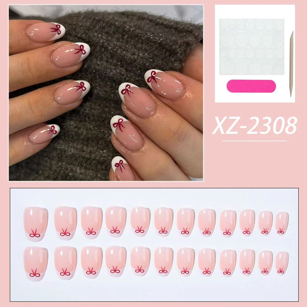 24 pieces of short almond-shaped nail tips with red bowknot designs, white French full-coverage stick-on manicure.