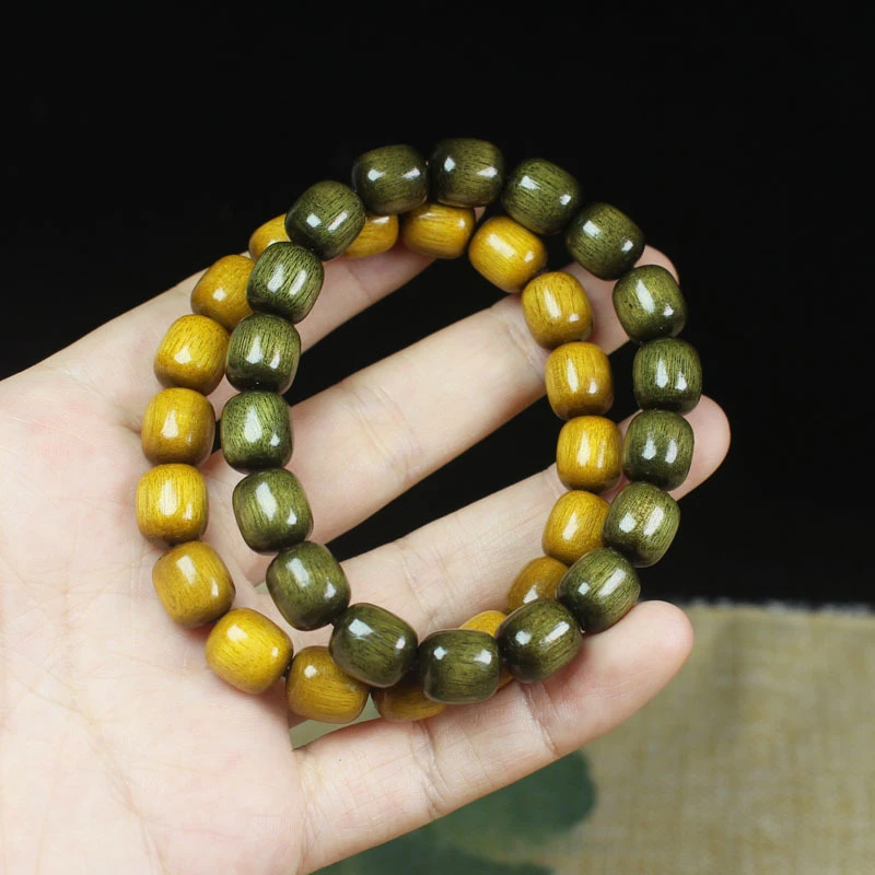 

Golden colored barrel bead , smooth grain nanmu dark wood bracelet, yellow and green
