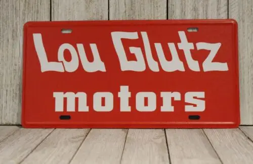 Lou Glutz Motors License Plate Tin Sign Vacation Movie Prop