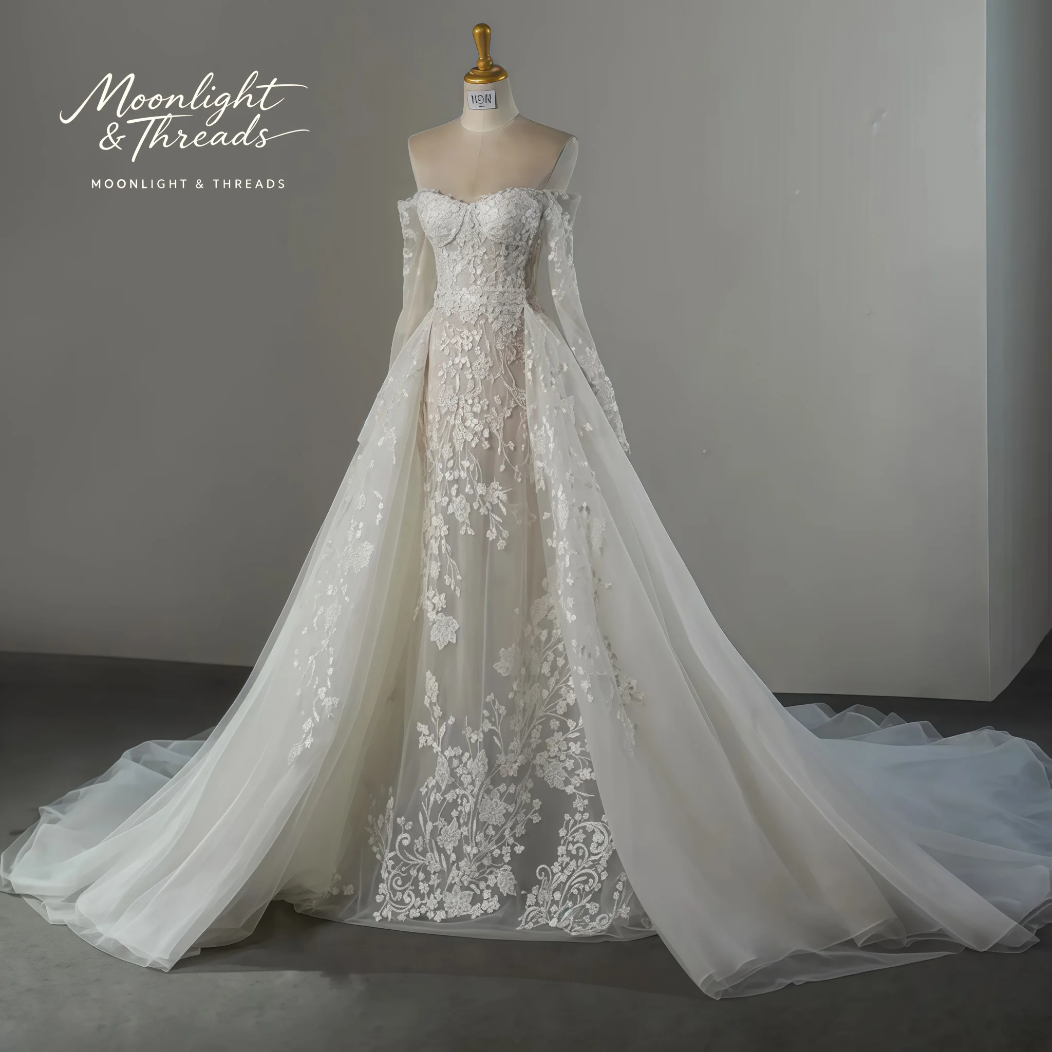 Ivory off-the-shoulder long-sleeved formal wedding gown featuring an A-line floor-length skirt and exquisite embroidery