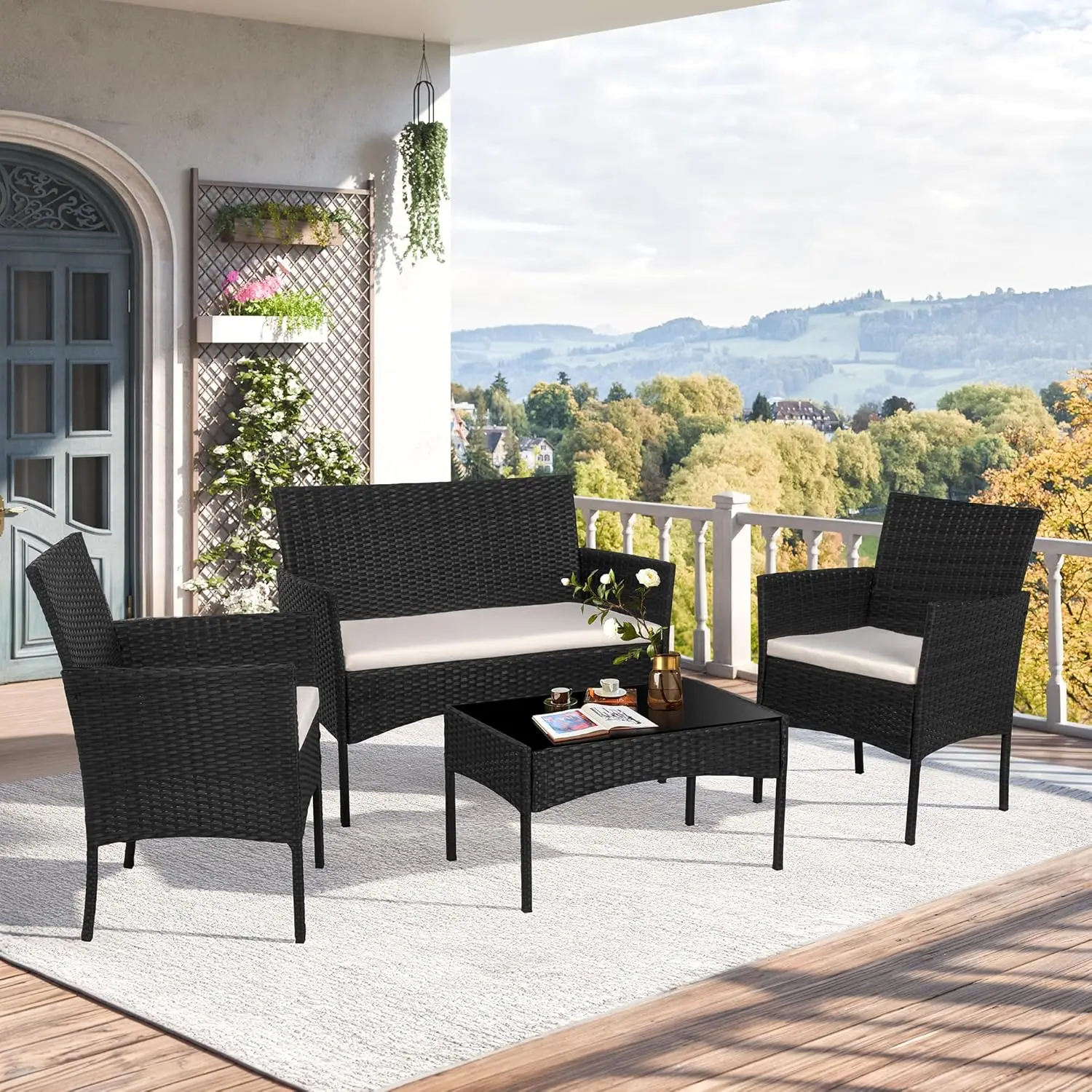 Black compact 4-piece rattan wicker outdoor conversation set fitted with tempered glass coffee table, multi-person seating for backyard, porch, garden, poolside and balcony