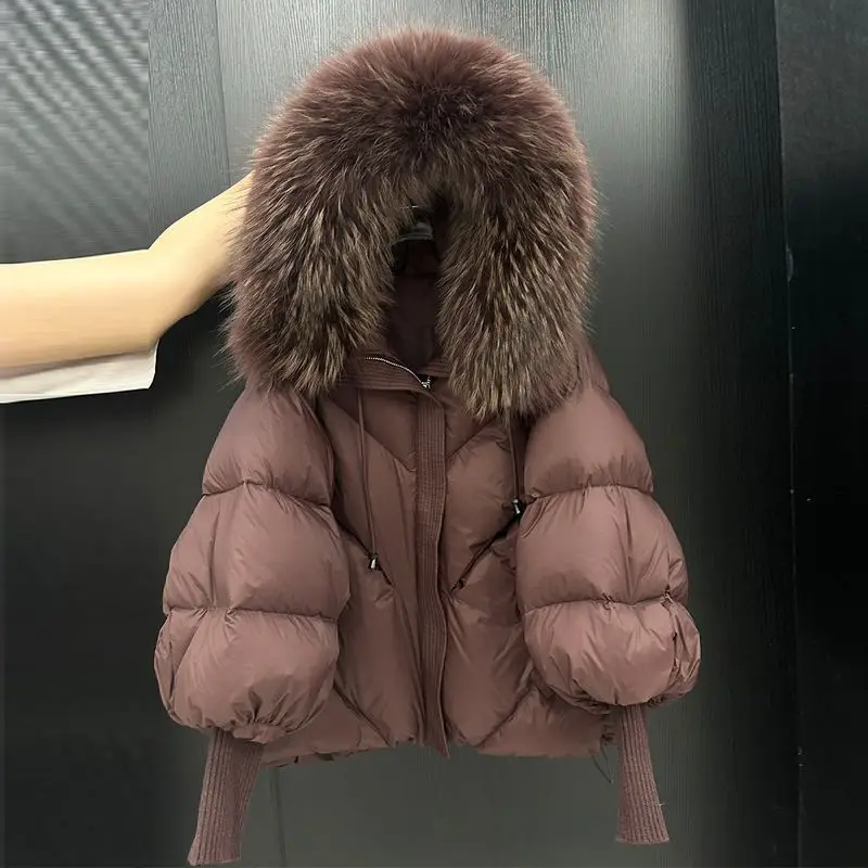 2026 秋冬新作ビッグファーカラーフード付きダウンジャケット女性のミディアムとロング厚く暖かいニットスリーブアウターウェア