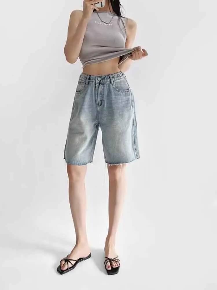 

European style new women's fashion versatile simple solid color elastic waist five-point denim raw edge shorts