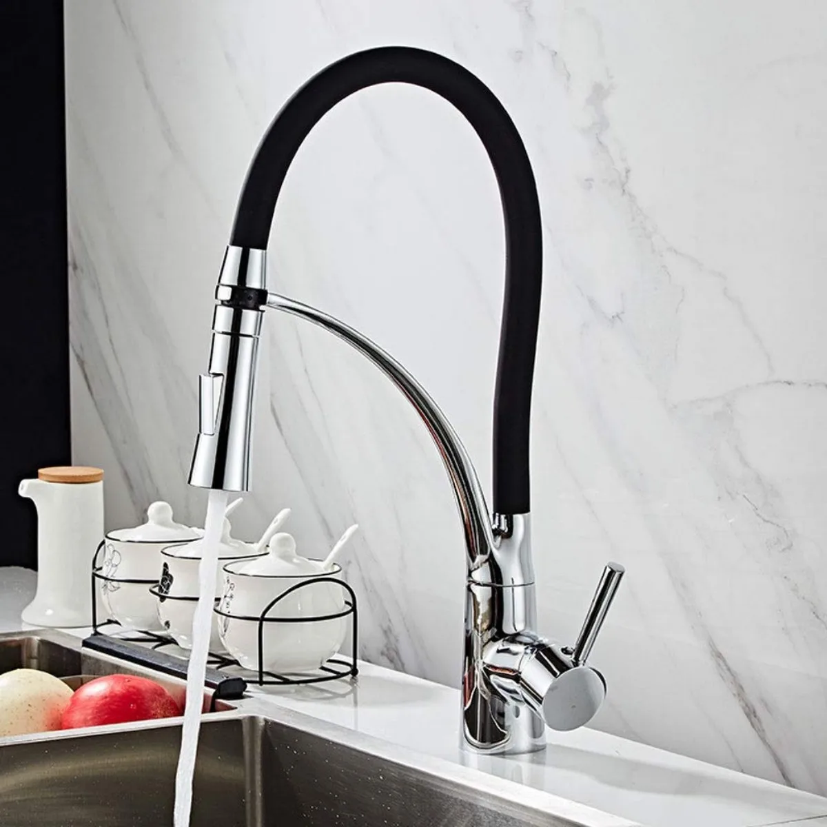 

Pull-out kitchen faucet with flexible silicone nozzle, single handle, pull-down brass gooseneck, and modern high-curve design.