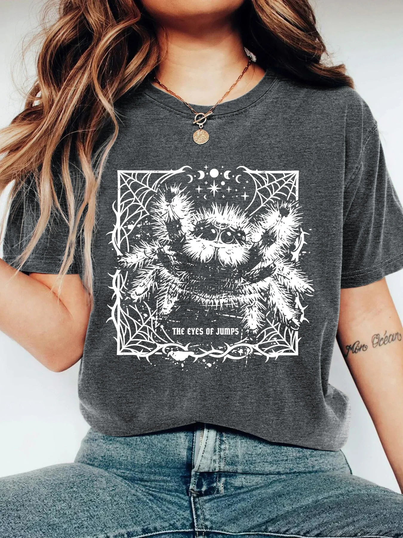 Short-sleeve top featuring a spider, web, and thorn motif within a star-and-moon-adorned rectangular frame women clothing