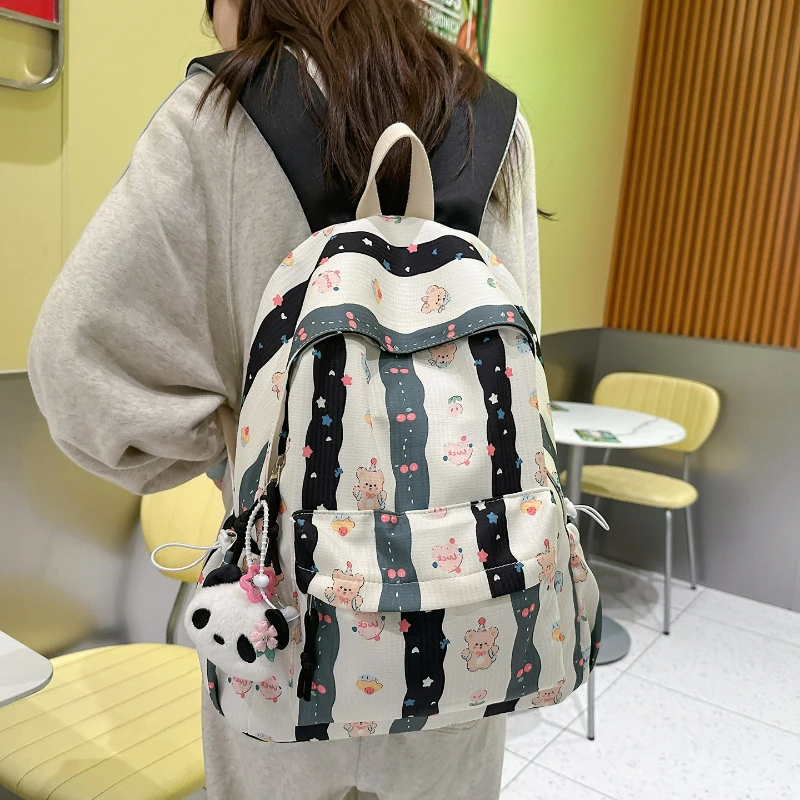 جديد لطيف الكرتون على ظهره المرأة سعة كبيرة حقيبة مدرسية موضة طباعة حقائب الظهر مريحة ومتعددة الاستخدامات الملمس حقيبة المدرب