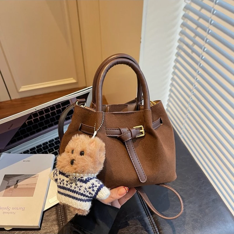 

Минималистичная коричневая замшевая мини-сумка через плечо, с винтажной текстурой и очаровательным брелоком-медведем, универсальная повседневная сумка для работы и прогулок