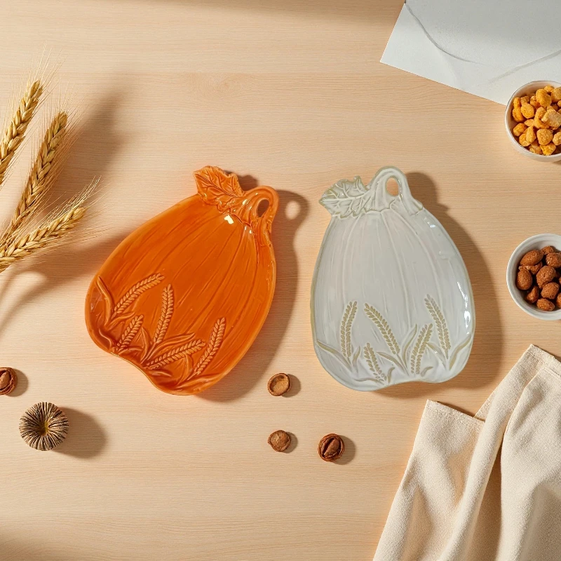 Handmade ceramic pumpkin plate with wheat embossed relief to decorate rustic pottery for autumn table setting