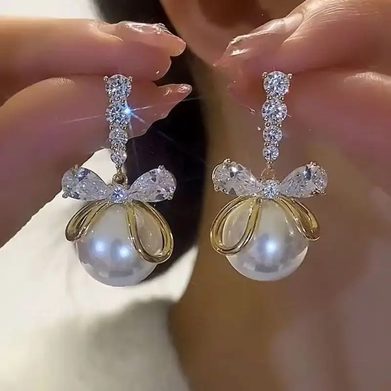

Super flash zircon bow pearl silver needle women's earrings are fashionable and atmospheric