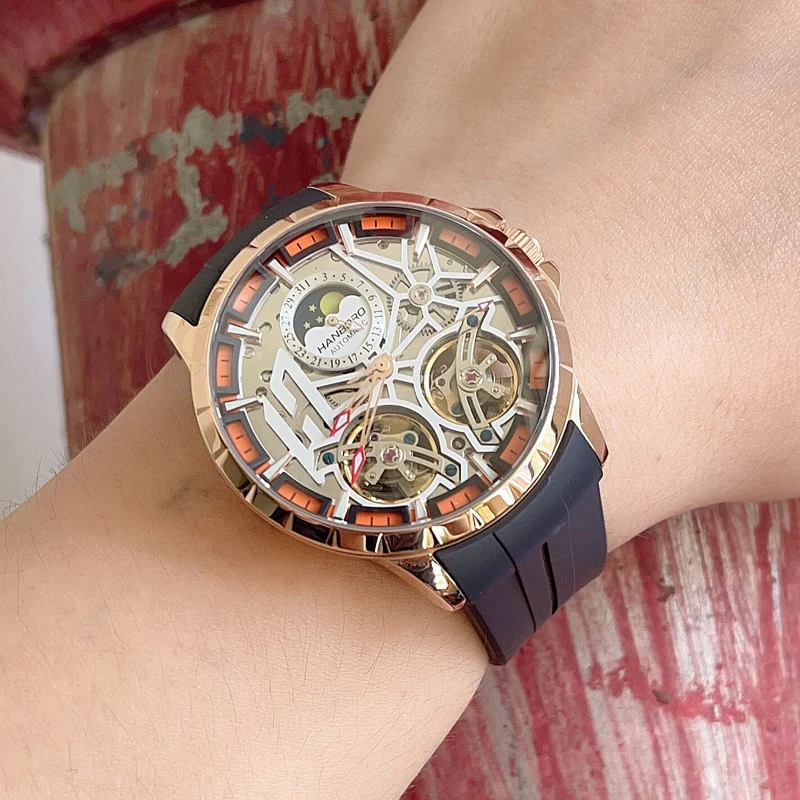 HANBORO ผู้ชายนาฬิกาอัตโนมัตินาฬิกาหรู 50M กันน้ําส่องสว่างนาฬิกาข้อมือ Hollout Out Dial Fly ล้อ Sapphire