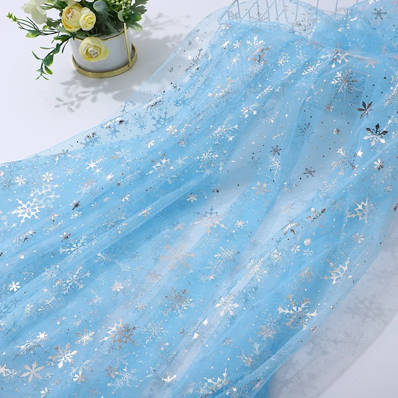 

Silver-embossed snowflake mesh fabric is used to sew children's skirts decorative tablecloths and headwear mesh fabric