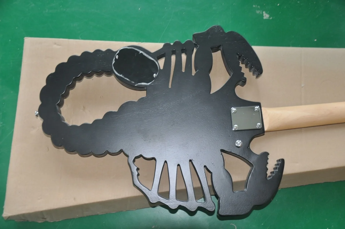 Musical InstrumentsThe factory customized 6-string scorpion shaped electric guitar is available in black stock.