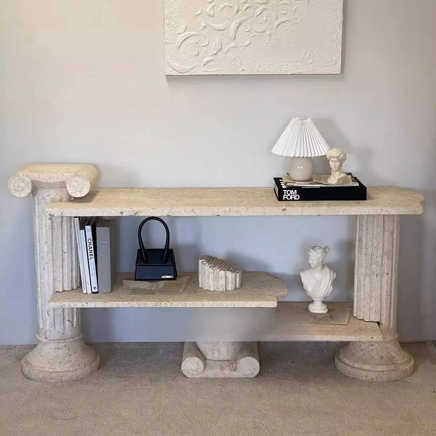 Natural travertine tea table, a few marbles on the edge of the entrance table, style ornaments