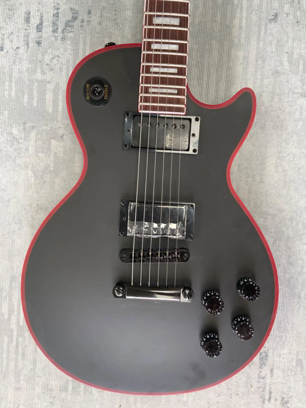 have Gib~ logo Electric Guitar, Black, Red binding, Red logo Jacob, Mahogany body, Rosewood fingerboard Made in China,