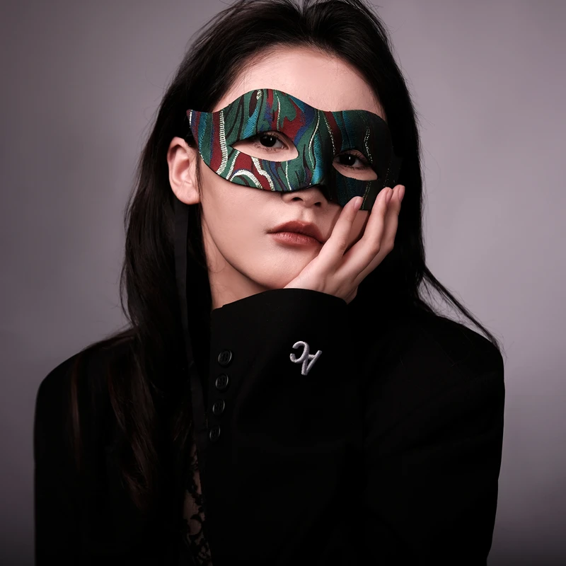 

The lady performs with a handmade mask on her half face, on the stage, in red color. It's a Douyin video for Halloween Christmas