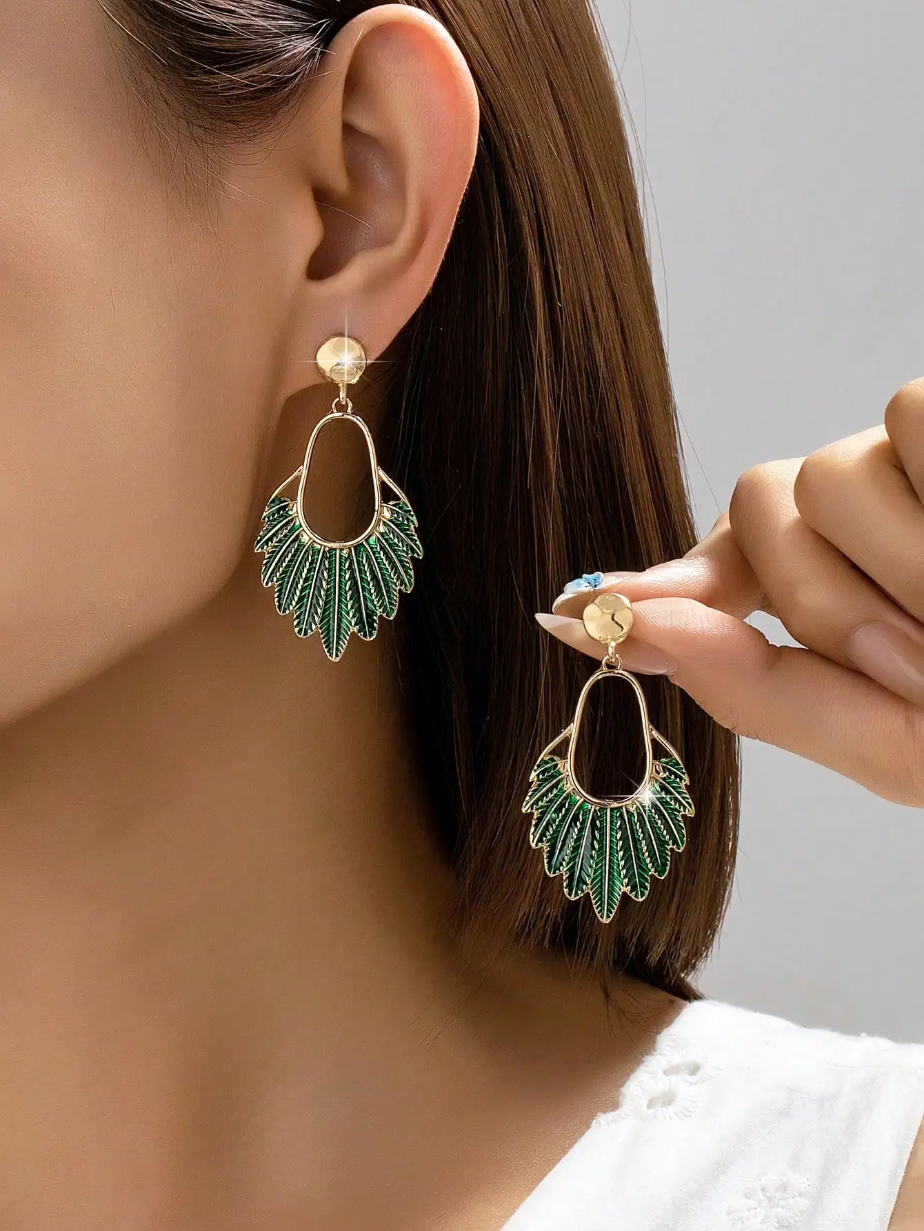 A Pair of Trendy and Fashionable Oil-Drip Leaf Earrings for Women, Featuring a Unique and Elegant Design That Is Versatile