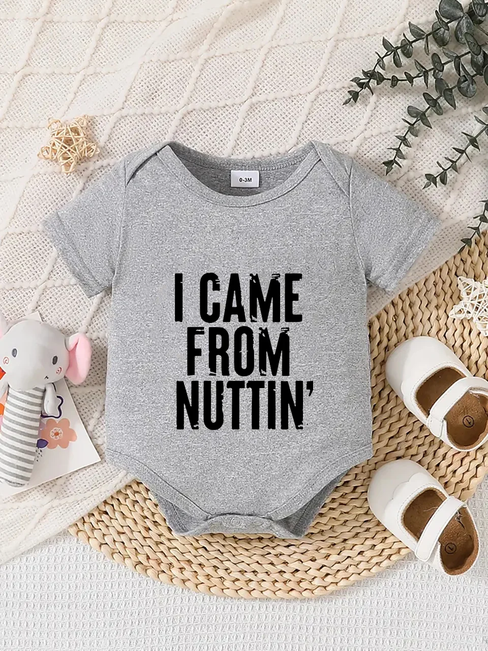 Playful letter-printed baby short-sleeve triangle bodysuit. Button closure for easy dressing