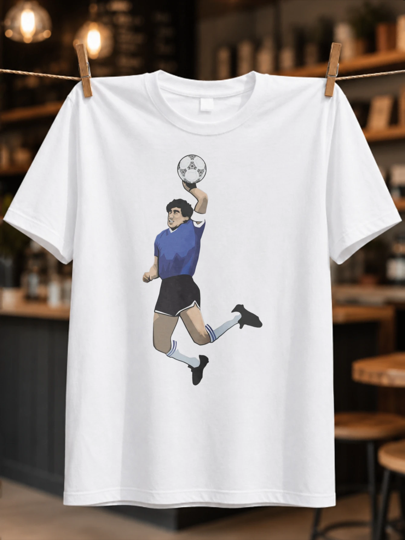 Diego Footballer illustrated blue kit jumping pose holding a ball clean vintage sports icon graphic  Unisex All T-Shirt