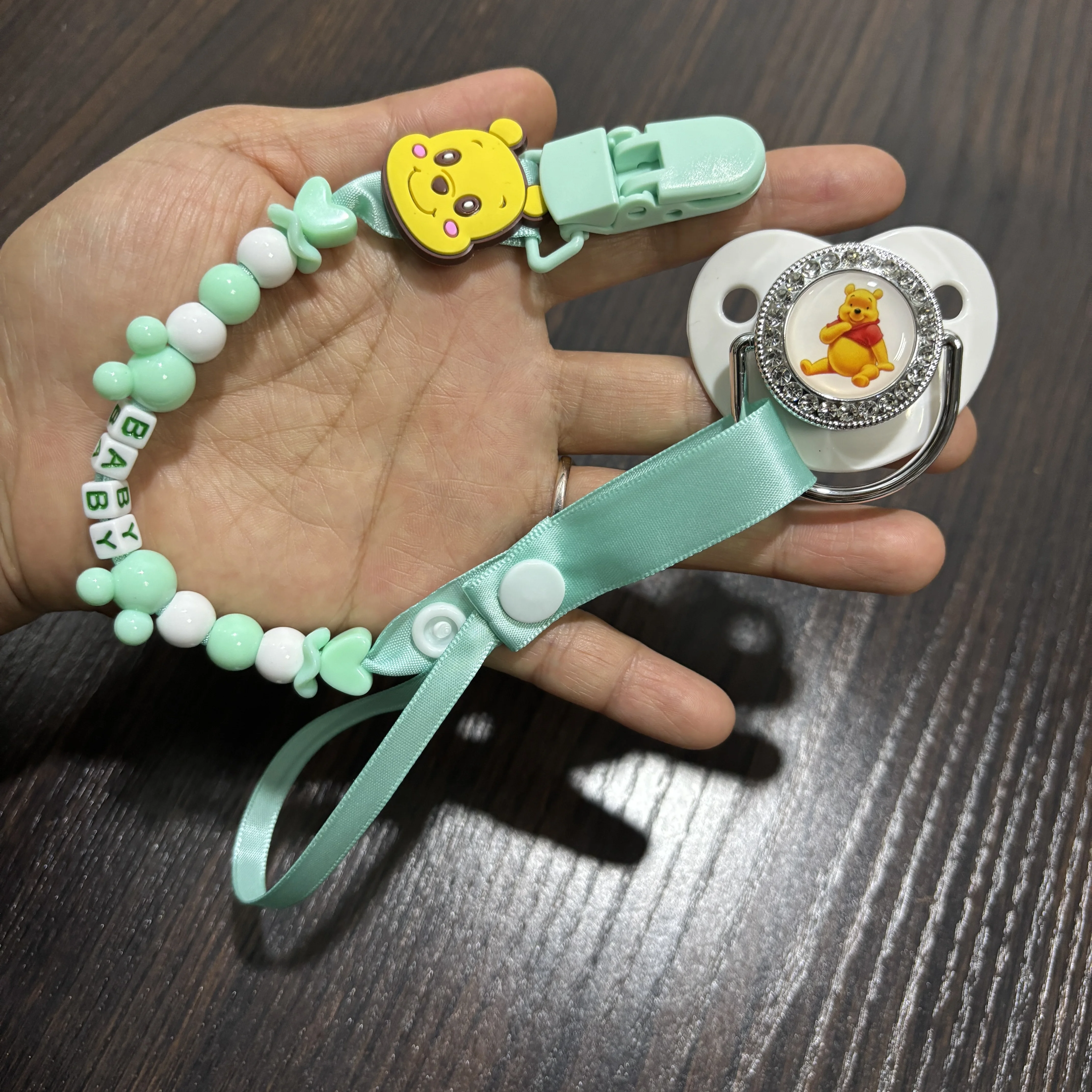 

A cute chewable pacifier and pacifier holder for newborns designed provide comfort and relieve teething discomfort for new mothe