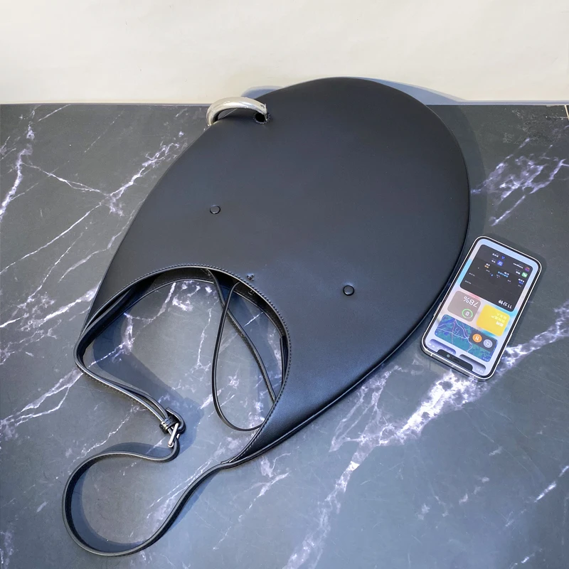 Bag worn underarm on model in urban setting