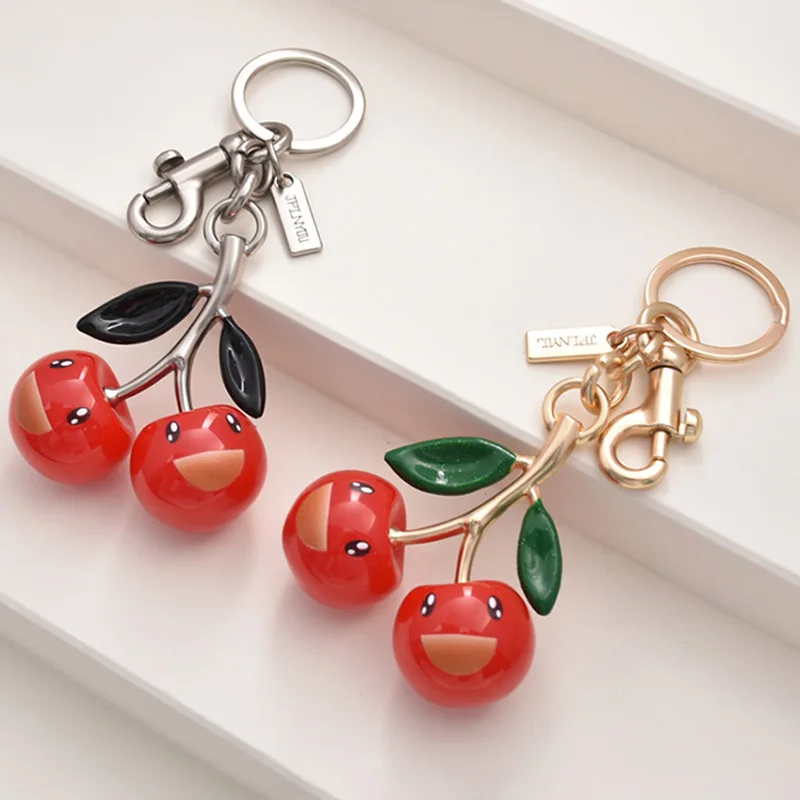 

Милая улыбающаяся вишневая сумка, кулон, модный брелок для ключей, изысканный автомобильный брелок, украшение из смолы, золото и серебро, двухцветный вид