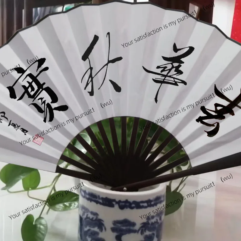 A large folding decorative fan mounted on a Chinese vintage wall