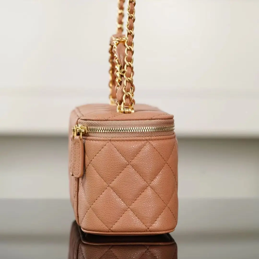 Camel-colored diamond-quilted caviar leather makeup case handbag, with woven gold chain top handle and shoulder strap, fully zippered closure.