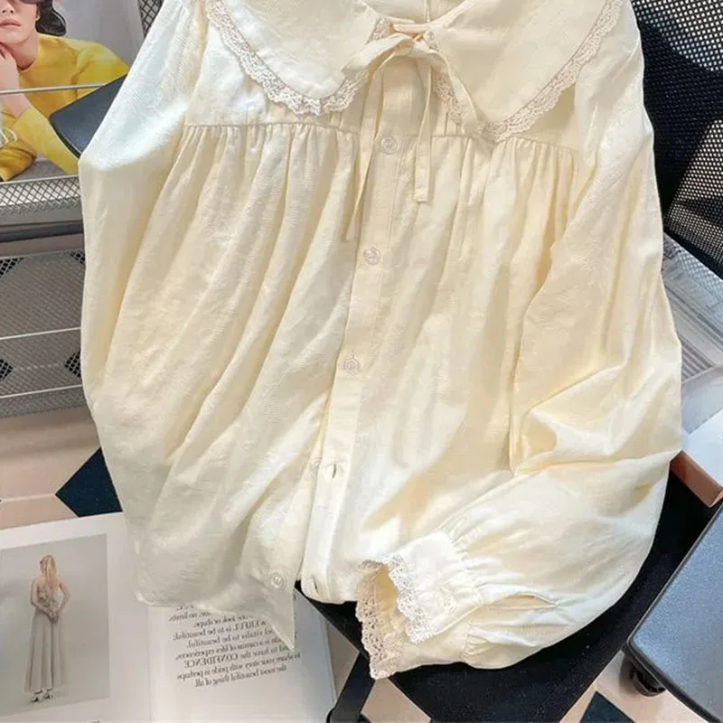 เสื้อเชิ้ตคอปีเตอร์แพนสไตล์ญี่ปุ่นน่ารักสำหรับผู้หญิง เสื้อแขนยาวผูกโบว์หวานๆ เสื้อทรงหลวมติดกระดุม เข้าได้กับทุกชุด สไตล์ Y2k