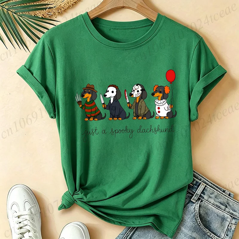 Casual women's short-sleeve gray graphic t-shirt featuring four cute Dachshund dogs dressed as classic spooky horror movie villains under text that reads just a spooky dachshund.