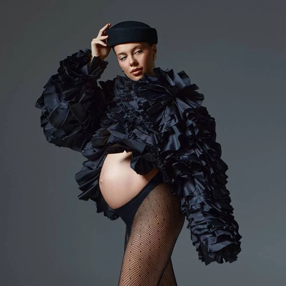 

Black Ruffled Jacket Features Dramatic Layered Design With Bold Volume And Textured Fabric Enhances Silhouette And Movement Perf