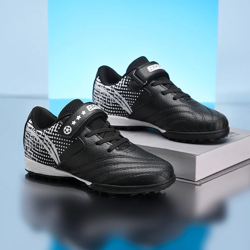 A pair of children's teenagers velcro turf football shoes black white gradient upper for PE class artificial grass trainingXN991