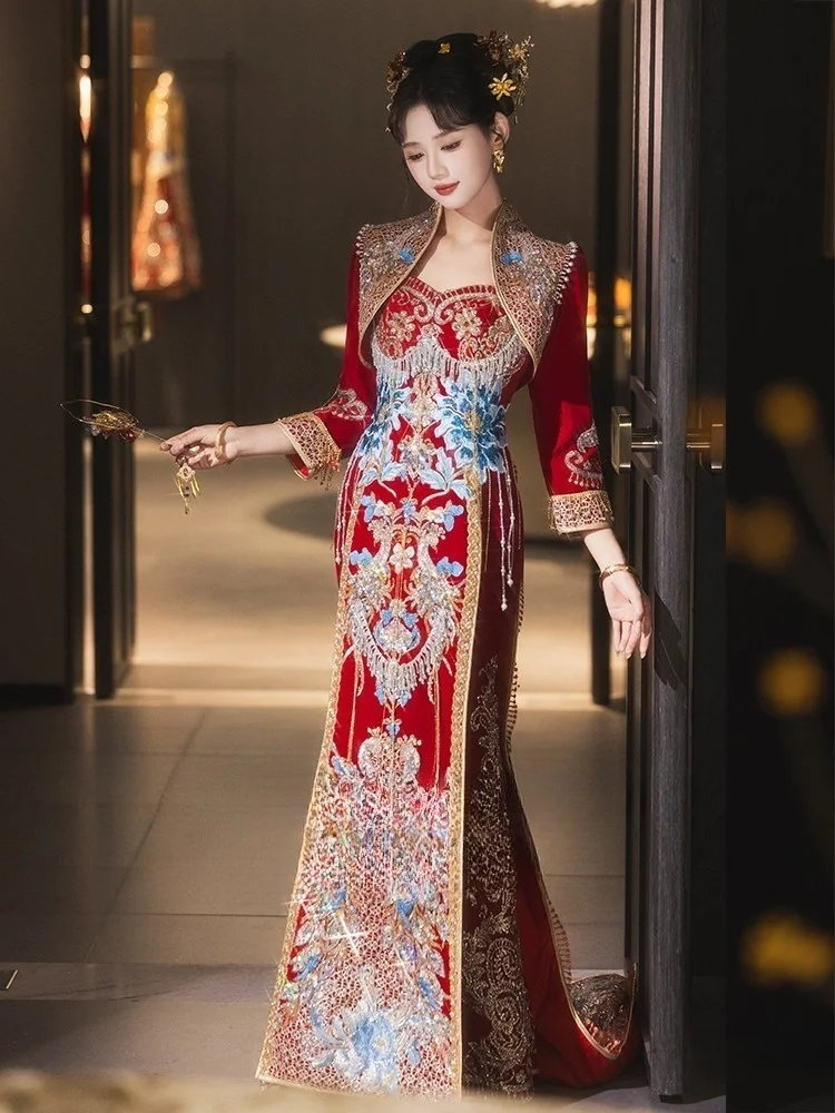 

New Chinese-style wedding dress with a long tail featuring phoenix crown and red veil as well elaborate dazzling attire