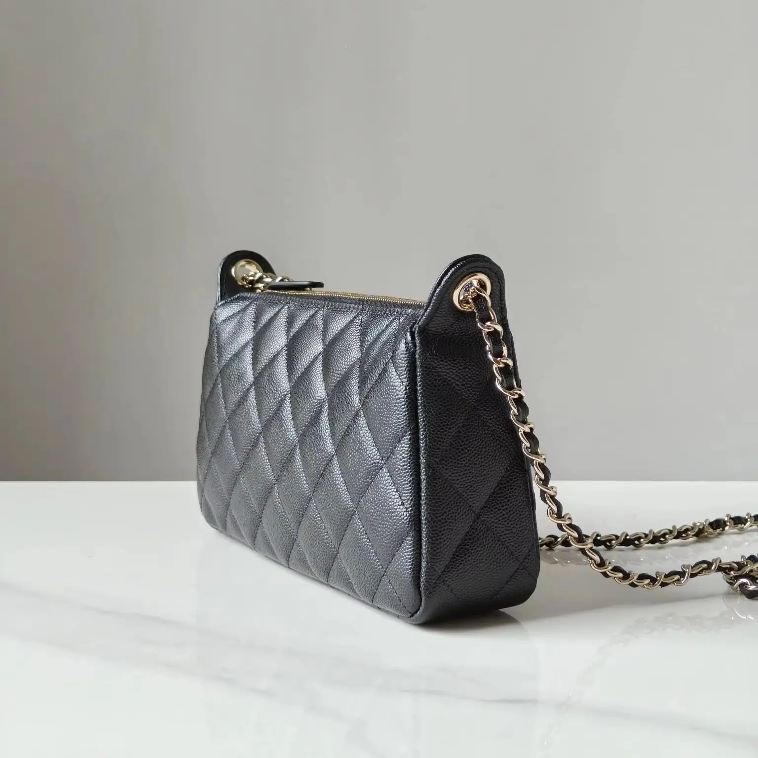

Classic black caviar leather crossbody bag, with quilted detailing and a versatile chain strap.