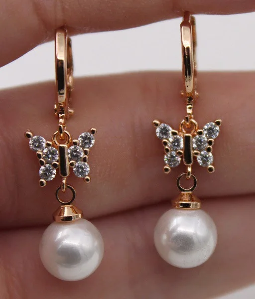 European-style ear pendants, ear clasps, earrings - 18k rose gold plated with a butterfly-shaped pearl at the center.