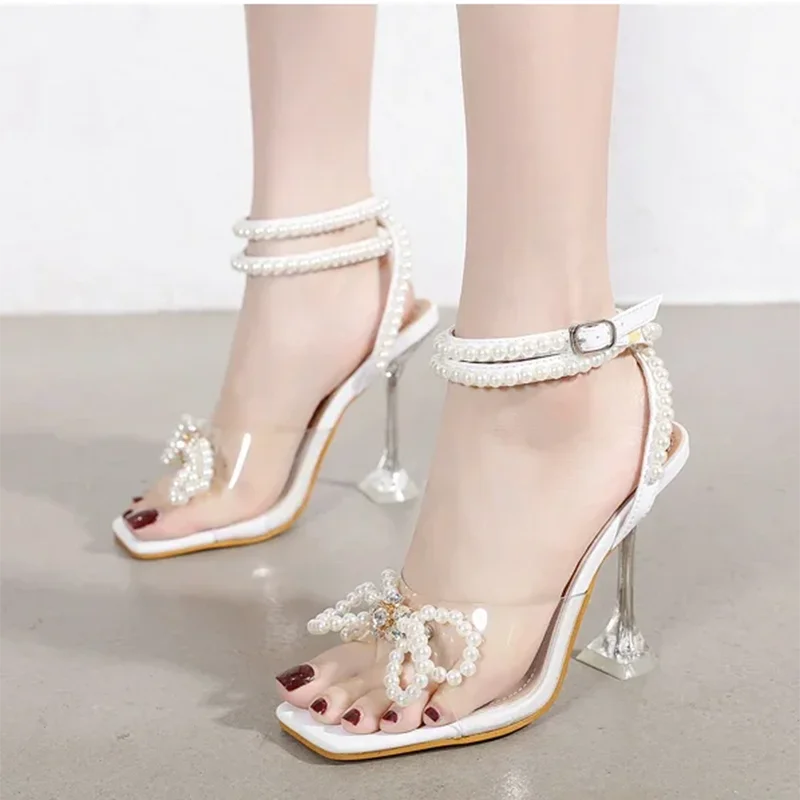 

Aneikeh блестящие сандалии на высоком каблуке с узким ремешком и квадратным носком, летние сандалии на высоком каблуке с бусинами, женская обувь для свадебной вечеринки с узлом-бабочкой и кристаллами