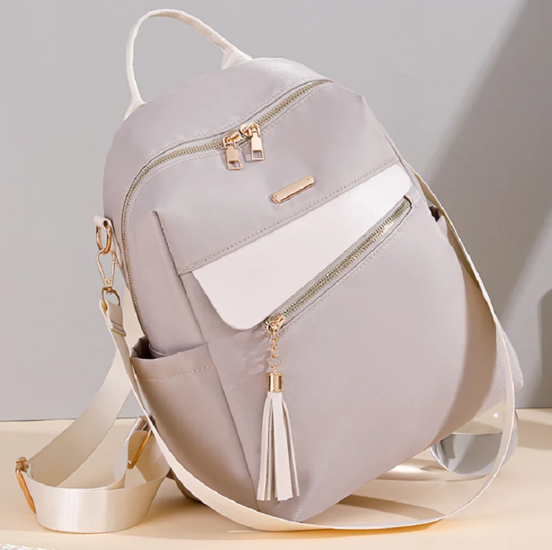 

2026 Korean Fashion Waterproof Oxford Large Capacity Travel Backpacks Women's Tassels Designer Shoulder Bags Laptop School Bag