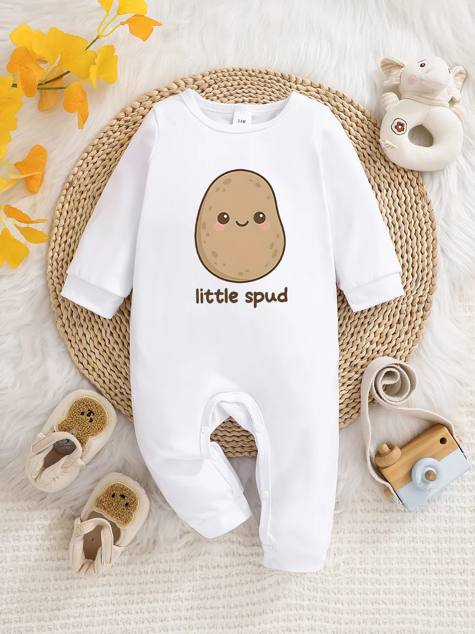A baby long-sleeved onesie with interesting letter prints. It features a buttoned design for easy putting on and taking off, and