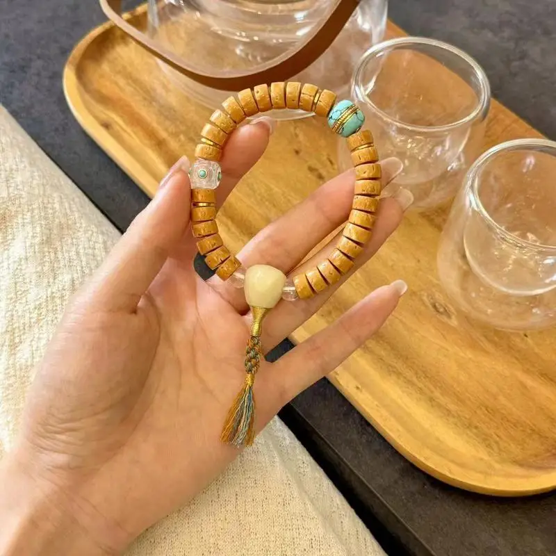 Peach pit straight-cut , paired with magnesite burger beads, sugar cube inlays, and large intestine-shaped snowflake glass
