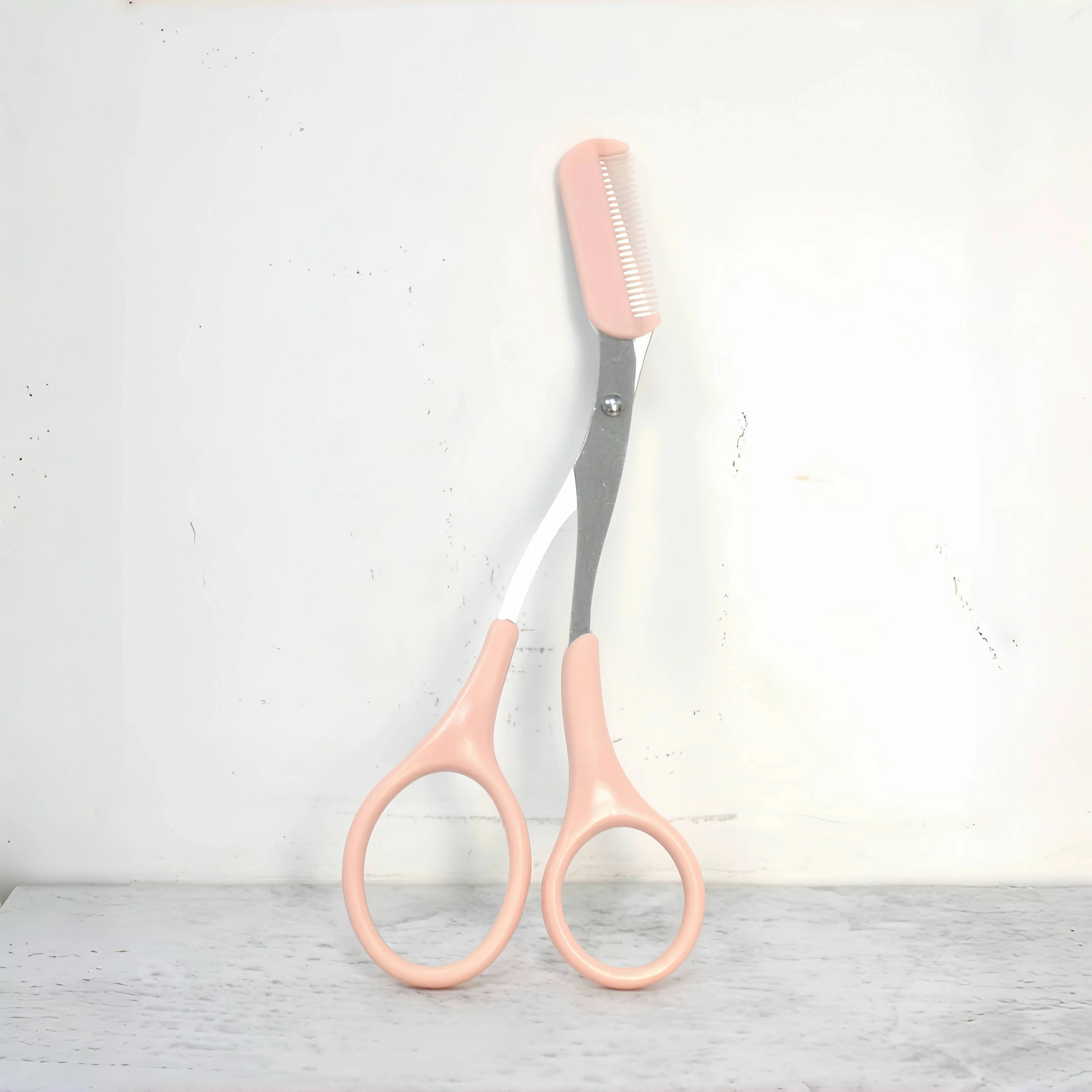 Pink eyebrow trimming scissors with built-in comb - stainless steel, precise grooming tool, creating perfect eyebrows