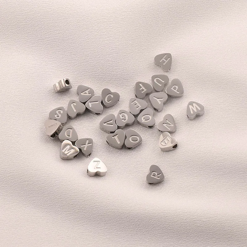 CARLIDANA High Polish Stainless Steel Silver Color 7*6mm Engraved Letter Alphabet Initial Perforated Heart Charm Accessories