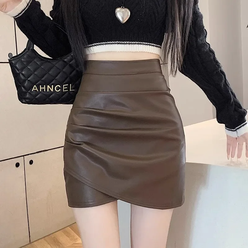 

Black PU leather half body skirt women's spring autumn high waist slimming irregular pleats hip hugging short skirt mini