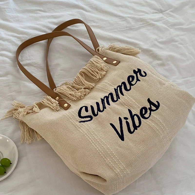 

2023 New Korean Letter Tassel Canvas Bag Women's Large Capacity Simple Commuter Student One Shoulder Tote Bag