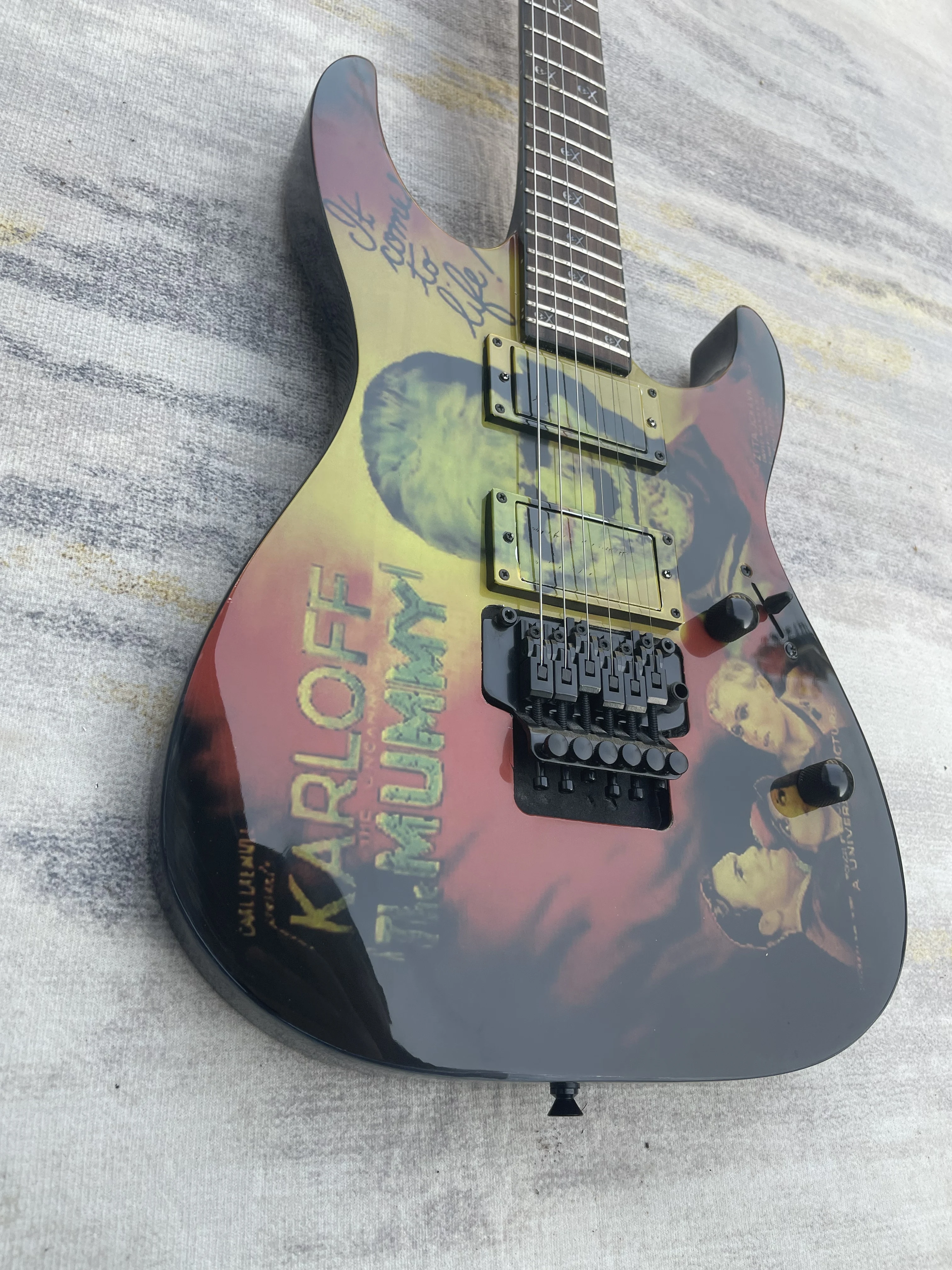 Retro Old Film Graphic Solid Body Electric Guitar Two Gold Covered Floating Tremolo Bridge For Rock Performance Free Shipping