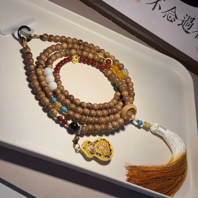 Long crossbody-style phone strap made of agarwood with a string of Bodhi cypress beads and a green sandalwood ring