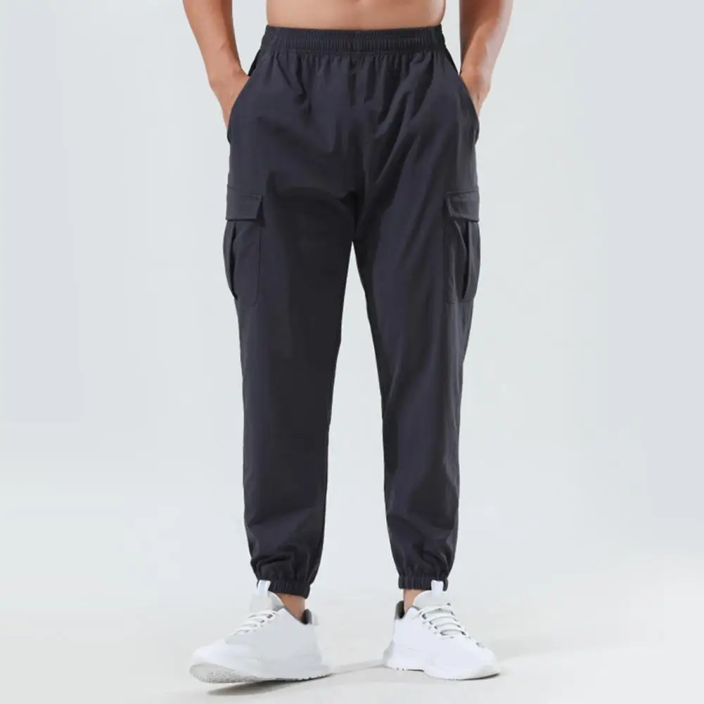 

Men Pants Elastic Waist Quick-drying Loose Solid Color Pockets Stretchy Daily Wear Casual Sport Gym Trousers Long Sweatpants