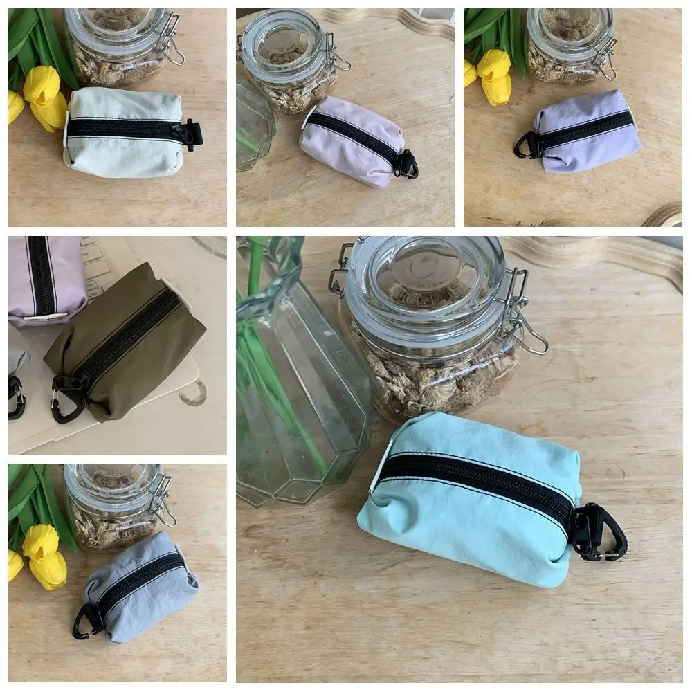 Monedero portátil de tela de nailon, estilo coreano, gran capacidad, cremallera, bolsa para artículos pequeños, bolsa de cosméticos ligera de Color sólido para auriculares