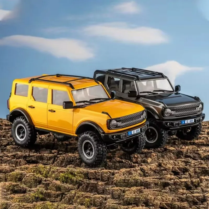 ของเล่นโมเดลจำลองเปลือกแข็งรถสำหรับปีนเขาทางวิบากแบบ FMS 1/18 Bronx Gold Rush Ford Wrangler mobil REMOTE CONTROL