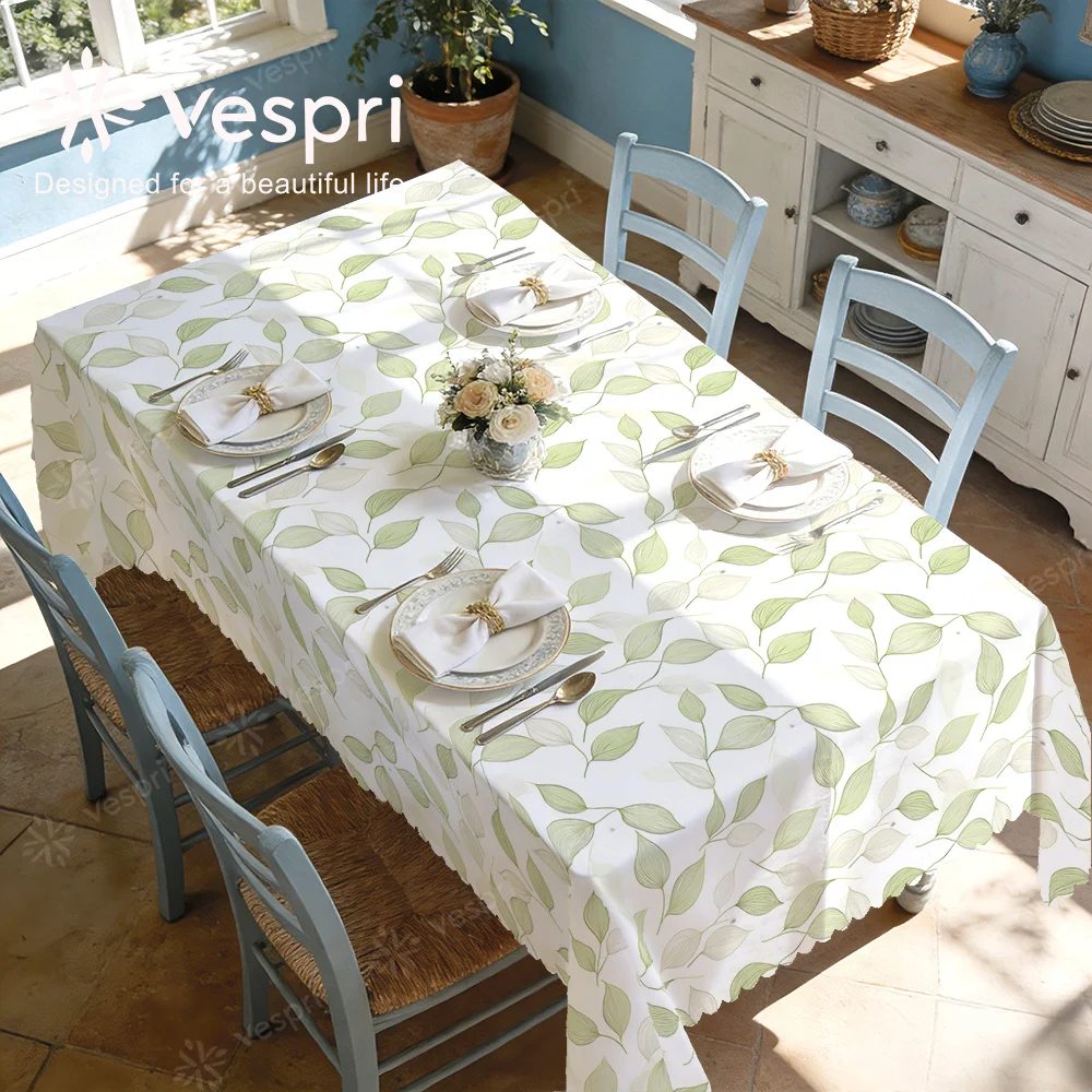 Vespri autumn tablecloth, with white and green decorations, chairs, dining table and bouquet.