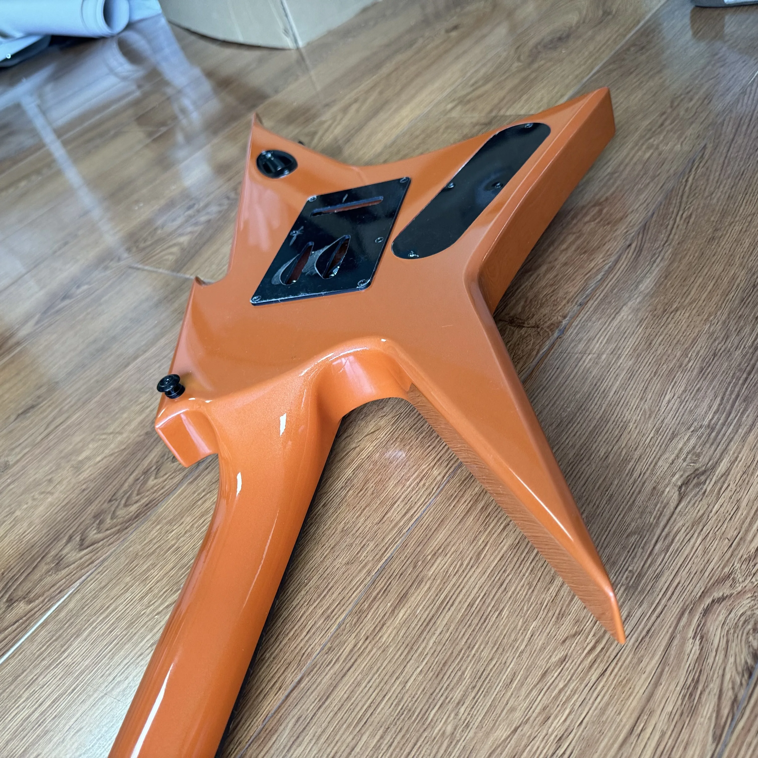 Orange Alien V-Shaped Electric Guitar With Floyd Rose Tremolo System - 24 Frets. Sharp-Edged Star-Shaped Body